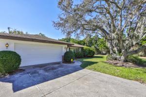 a house with a garage and a driveway at Lazy Manatee Pool Home in Bradenton
