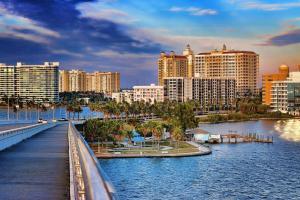 a city with a bridge over a river with buildings at Lazy Manatee Pool Home in Bradenton