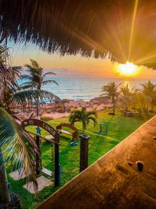 a view of the beach from a resort with the sunset at Raio de Sol Residence in Canoa Quebrada