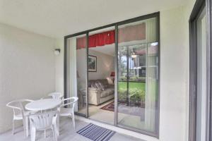 a living room with a table and chairs and a couch at Shorewalk Condominium in Bradenton