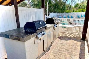 a outdoor kitchen with a grill on a patio at Shorewalk Condominium in Bradenton