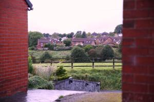 a view of a village from a brick building at The Lodge Oldham in Oldham