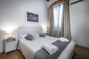 a bedroom with two beds with towels on them at Roommo Beccaria in Florence