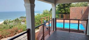 a balcony with a view of a swimming pool at Zinkwazi Beach townhouse in Zinkwazi Beach