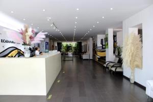 a lobby of a store with a counter and chairs at Hotel Bucaramanga Plaza in Bucaramanga