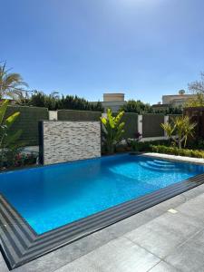 a large blue swimming pool in a yard at Al Sawah Stand Alone Villa With Private Pool in Sheikh Zayed
