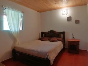 Postel nebo postele na pokoji v ubytování Nuestro Bosque I