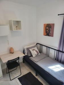 a small bedroom with a bed and a desk at Cosy 2 bedroom near sea Costa del Silencio in Costa Del Silencio