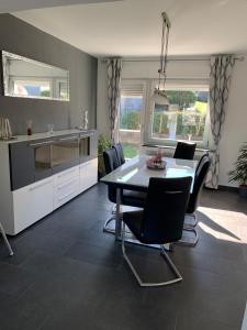 a kitchen and dining room with a table and chairs at Fewo Linde OG in Olpe