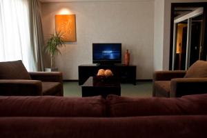 a living room with a couch and a tv at Epic Hotel San Luis in La Punta