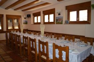 a dining room with a long table and chairs at Las Abadías in San Felices