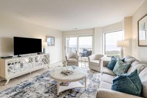 a living room with a couch and a tv at Sea Cloisters 409 in Hilton Head Island