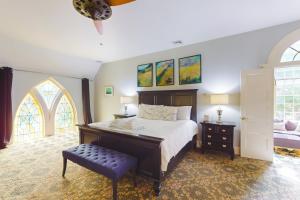 a bedroom with a large bed and a window at The Belfry Meetinghouse in Sandwich