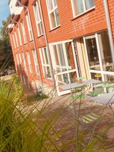 a building with tables and chairs in front of it at Thöles*** Hotel in Vilsen in Bruchhausen-Vilsen