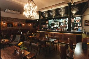 a restaurant with tables and chairs and a bar at The Bull and The Hide in London