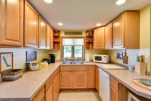 a large kitchen with wooden cabinets and a sink at Waterfront Chautauqua Lake Retreat Dock, Kayaks! in Mayville