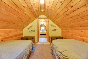 a bedroom with two beds in a log cabin at Waterfront Chautauqua Lake Retreat Dock, Kayaks! in Mayville