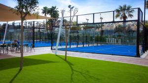 a tennis court inside of a building with green grass at Four Bedroom Mimosas Villa With A Private Pool in Atamaría