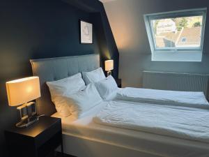 Postel nebo postele na pokoji v ubytování DK Hotel Heidelberg