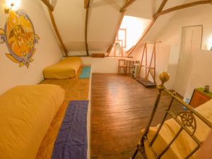 a attic room with two beds and a wooden floor at Anata Hostal in La Paz