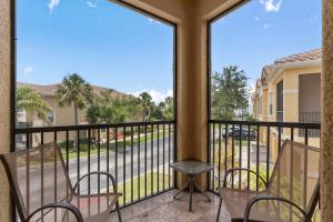 a balcony with chairs and a view of a street at A hidden Gem in plain sight in Orlando