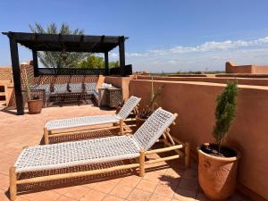 two chairs and a gazebo on a patio at Palm View in Marrakesh +20 photos