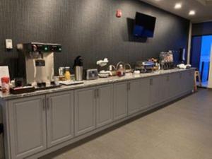 a kitchen with a long counter with a counter top at Park Inn by Radisson Edmonton Airport in Leduc