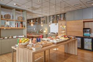 a large kitchen with a table with food on it at Akureyri - Berjaya Iceland Hotels in Akureyri +35 photos