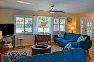 a living room with a blue couch and a tv at Mermaid Shores in Sarasota