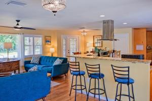 a kitchen and living room with blue bar stools at Mermaid Shores in Sarasota