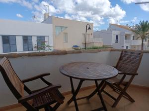 a patio table and two chairs on a balcony at Cabo de Palos VVMU 4780-1 in Cabo de Palos