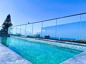 a swimming pool with a view of the ocean at Zar in Amanzimtoti