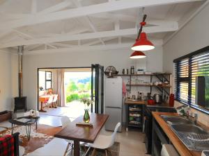 a kitchen with a table and a dining room at Sunset View Self catering Cottage in Underberg