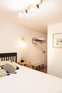 um quarto branco com uma cama e uma mesa em L'Atelier - Warm Porto Loft em Porto