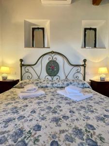 a bedroom with a bed with two towels on it at Podere Montale Il Borgo in Seggiano
