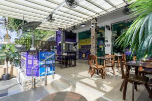 a restaurant with tables and chairs and a patio at The Great @Patong Hotel in Patong Beach