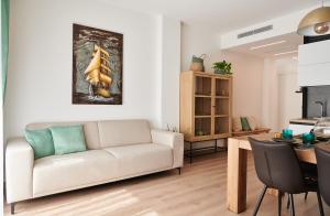 a living room with a couch and a table at ALLOGGIO MARGHERITA in Treviso