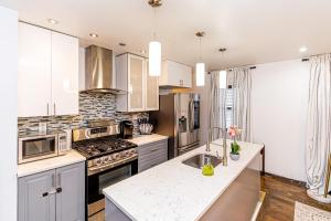 a kitchen with a sink and a stove top oven at Luxury in the Heart of Brooklyn in Brooklyn