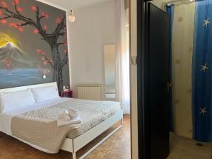 a bedroom with a bed with a painting on the wall at X Hotel in Punta Marina
