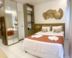 a bedroom with a bed with two towels on it at Porto Beach Resort - Makia Beach Experience in Porto De Galinhas