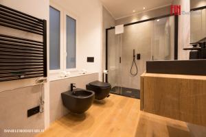 a bathroom with two black toilets and a shower at Mazzini House by Holiday Home 24 in Genova +14 photos