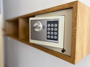 a safe on a wooden shelf in a room at Hotel Casa Agustina in Cartagena de Indias