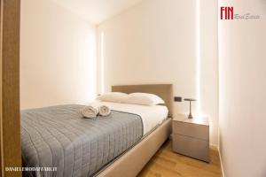 a bedroom with a bed with two towels on it at Mazzini House by Holiday Home 24 in Genova