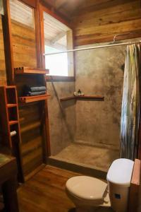 a bathroom with a shower and a toilet at Jungle beach 2 bedroom cottage in Bocas del Toro