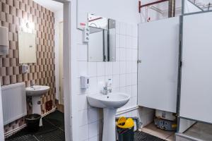 a bathroom with two sinks and a mirror at HOSTEL SPORT BUCHAREST in Bucharest
