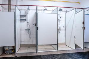 two stalls in a bathroom with white tiles at HOSTEL SPORT BUCHAREST in Bucharest +30 photos