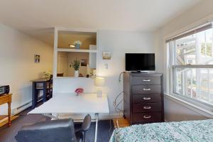 a bedroom with a desk and a bed and a window at My Happy Place in Provincetown