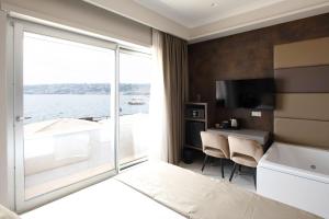 a hotel room with a view of the water at Imperatrice Suites in Naples