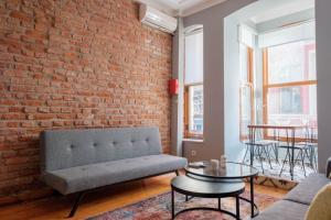 a living room with a brick wall and a couch at Rustic Stone Flat 5 min to Taksim Square in Istanbul