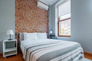 a bedroom with a brick wall and a bed at Rustic Stone Flat 5 min to Taksim Square in Istanbul
